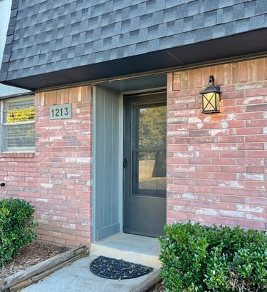 a charming front door of a townhouse