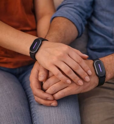 Couple holding hands while wearing matching black smart wristbands with glowing purple indicators