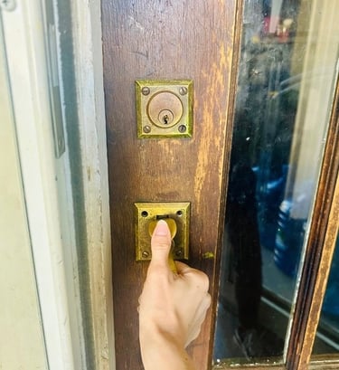 Hand on home door during lockout— representing emergency residential service locksmith in Candler, NC