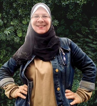a woman wearing a hijab and smiling
