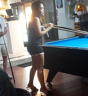 Thai woman playing pool at bar on Soi 94 in Hua Hin