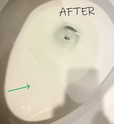 Toilet bowl clean and bright with a green arrow showing where the ring used to be