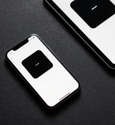 A top-down photograph of a smartphone and a tablet on a dark charcoal surface in a North American / US professional setting. Both screens display a consistent, modern brand identity with a black and white color scheme.