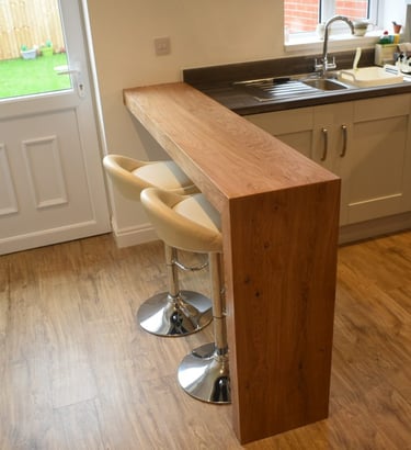 Breakfast bar. L shaped table with mitred joint made from oak veneered ply.