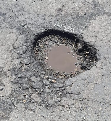 Pothole that needs repaired on parking lot job