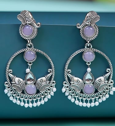 a pair of earrings with a purple and white flower