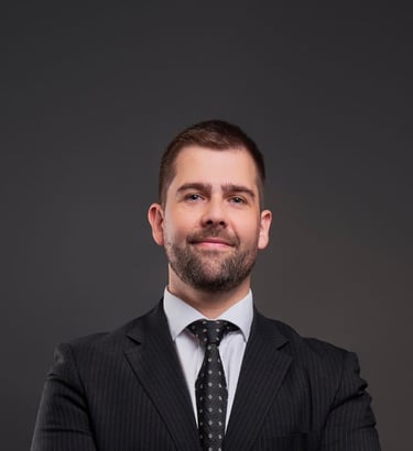 a man in a suit and tie with a watch on his wrist
