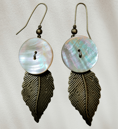 Iridescent mother of pearl shell and antique bronze leaf dangle earrings for boho jewelry fashion.