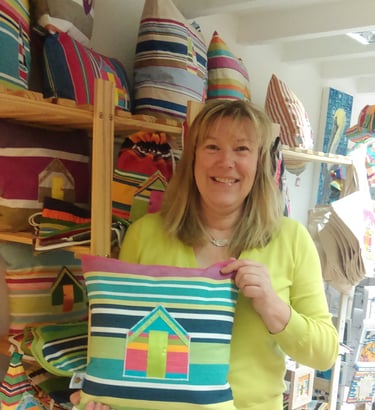 Lesley holding beach hut cushion