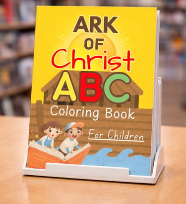 Ark of Christ ABC coloring book for children displayed on a stand in a library.