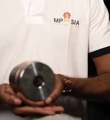 MP Asia Engineering Staff holding a CNC Precision Tool
