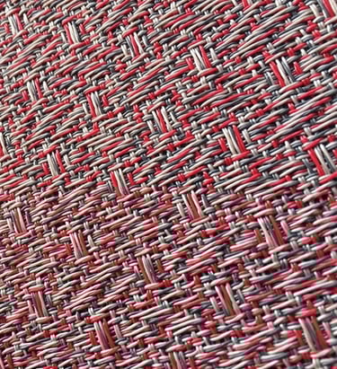 a close up of a red and white woven fabric with a red and white background