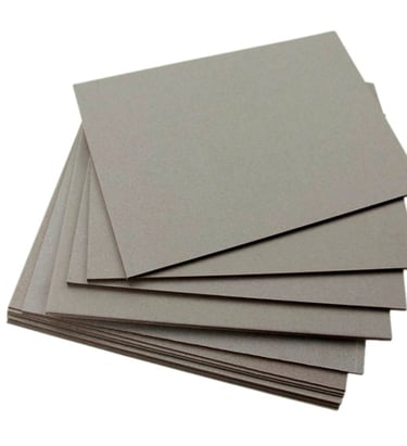 a stack of flat paper boards