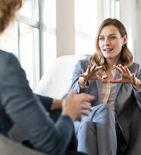 Visuell identitets eksempel – ADHD Arbeidsglede, med person som viser visuelt element med hendene.