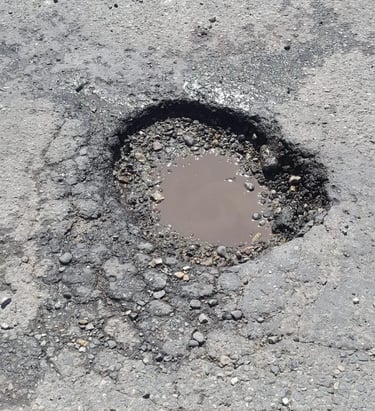 Pothole that needs repaired on parking lot job