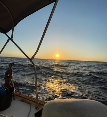 a man sitting on a boat in the ocean