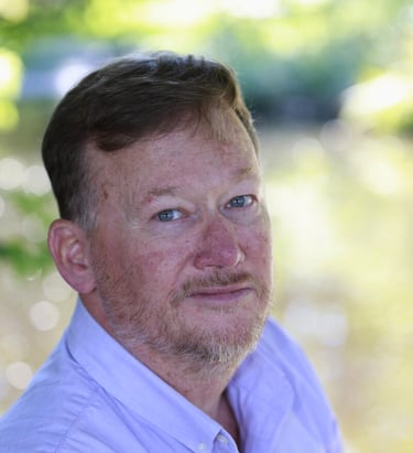 db gibb with a beard and a white shirt