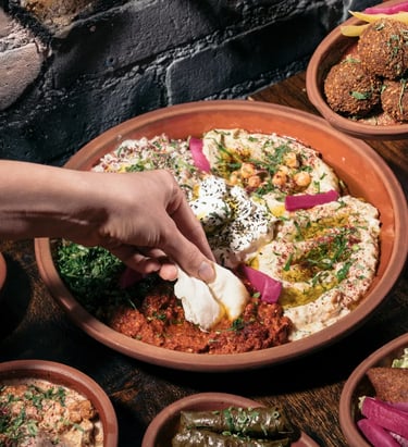 al badawi labneh and hummus dips being served