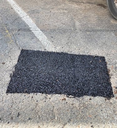 Finished unsealed parking lot pothole repair