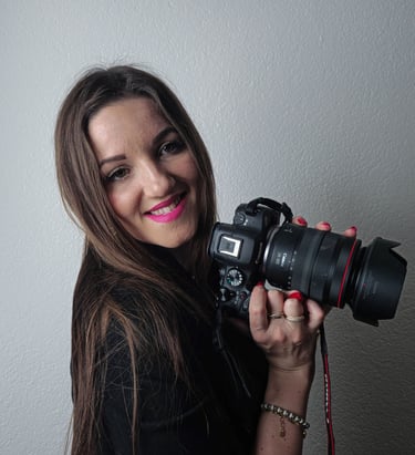 me holding a camera and smiling