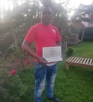Founder of Rakai Vulnerable Home Center holding a certificate