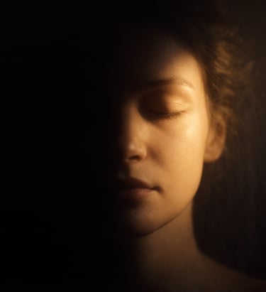 Soft light gently illuminating a person’s face, representing awareness revealing what is already pre