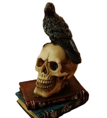 an ornament depicting a raven on a human skull set on two ancient grimoires