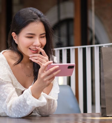 a woman sitting at a table with a shopping bag