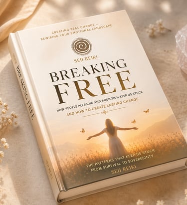 A self-help book titled Breaking Free by Seii Reiki rests on a stone surface with rose quartz and dried flowers.