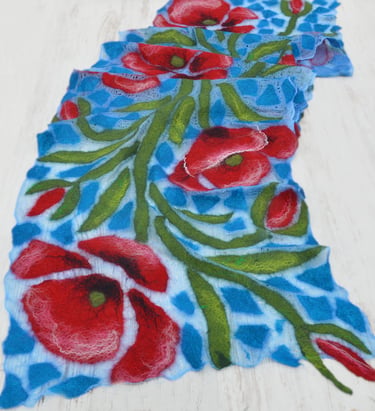 Handmade blue nuno felted scarf featuring vibrant red poppy flowers and green leaves.