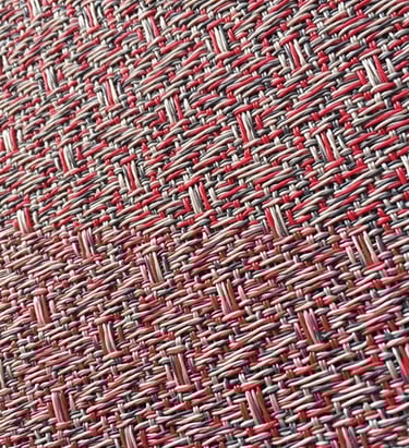 a close up of a red and white woven fabric with a red and white background