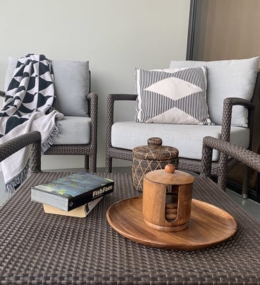 a wicker chair with a book and a book