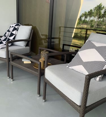 a patio with a couch and chairs and a table
