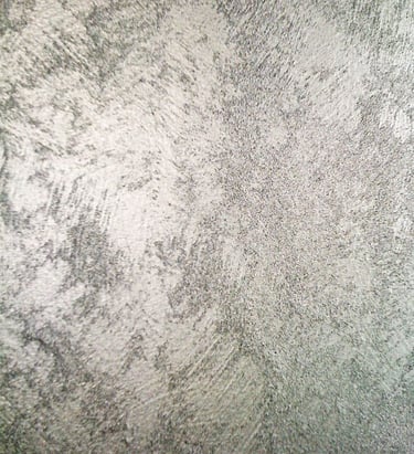 A cool silver paint sample showing off its shimmering grainy texture.