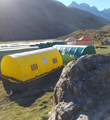 a group of tents with tents and tents in the background