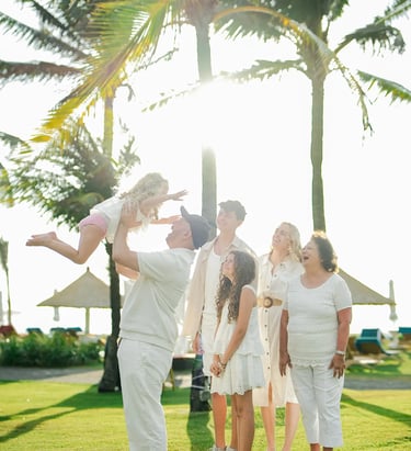 Family portrait captured during golden hour in the tropical gardens of Ayodya Resort Bali