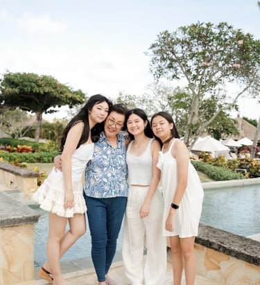Three sisters walking together naturally during a relaxed family photography session at Ayana Jimbaran Bali