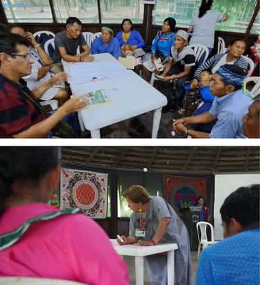 Indigenous Amazonian people attending a community workshop and planning meeting in a traditional building.