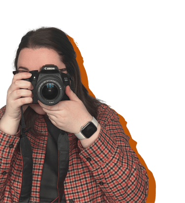 A women (Erin, owner of EB Socials) pointing a canon camera at the camera