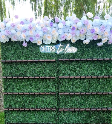 Champagne wall with lavender and white top flower arrangement.