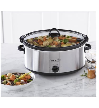 a crock pot slow cooker with stew cooking