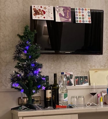 Christmas tree and cards up in hotel room