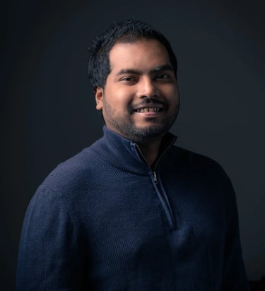 a man in a blue sweater in a dark background
