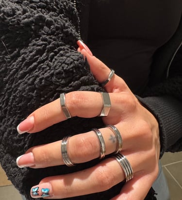 a woman's hands with rings on her fingers