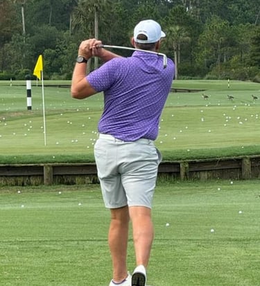 Men’s performance golf polo in purple on golf course