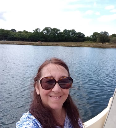Artist in her boat on the river Beaulie, UK