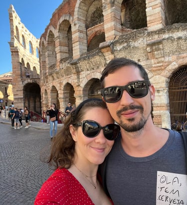 a man and woman standing in front of colosseum