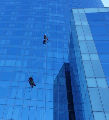 Two men hanging from a high riser