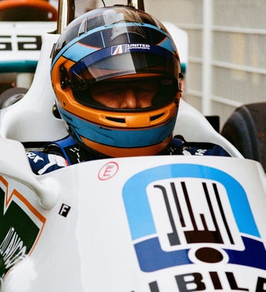 Zak Brown sat in a racing car with his helmet on before a race