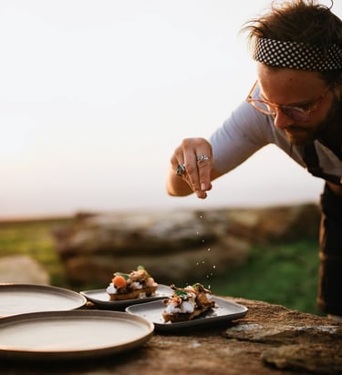 a man is sprinkling food on a table